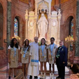 Girl Scouts and Vincentian Priest in front of Our Lady of the Miraculous Medal Shrine