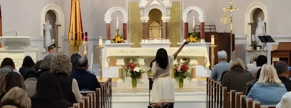 Immaculee Ilibagiza kneeling at altar