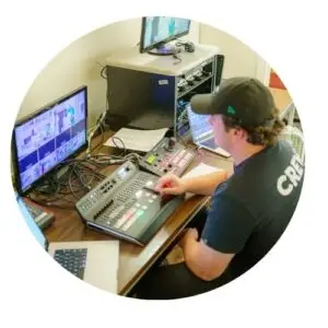 Man at laptop managing Perpetual Novena livestream.